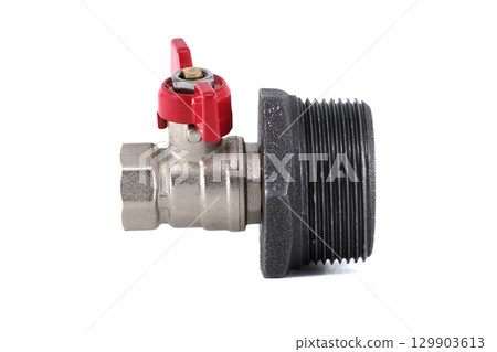 A close-up view of a ball valve with a red handle and threaded pipe fitting. 129903613