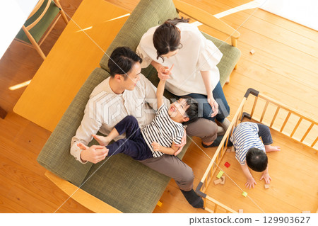 A young couple with a child playing in the living room A young couple with a child playing in the living room 129903627