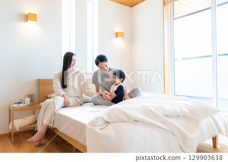 Young family having a conversation in the bedroom Young family having a conversation in the bedroom 129903638