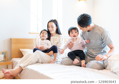 Young family bedroom parents and children Young family bedroom parents and children 129903643