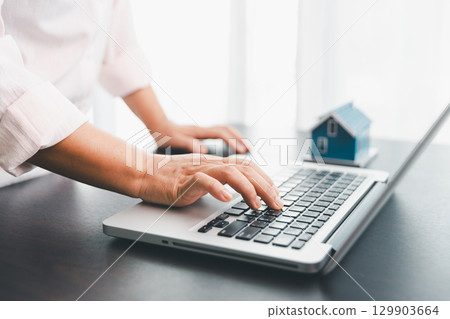 Calculator to check and summary expense of home loan mortgage for refinance plan , people lifestyle concept. Home agents are using calculator to calculate the loan period each month for customer. 129903664