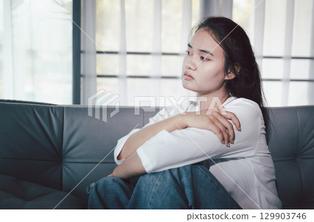 Sorrowful woman sat alone, overwhelmed by emotion, her sad and unhappy expression revealing deep despair, stress and distress left feeling depressed. sorrowful sad, despair alone, depressed stress Sorrowful woman sat alone, overwhelmed by emotion, her sad and unhappy expression revealing deep despair, stress and distress left feeling depressed. sorrowful sad, despair alone, depressed stress 129903746
