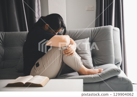 People and hope concept. Close up face female feeling hope and faith. Woman praying. christianity faith, international day of prayer, female lost in thoughts feel lonely depressed pondering 129904062