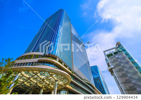 Tokyo cityscape in Japan: A rare sight: an airplane passing by... Extreme heat, developed clouds over Takanawa Gateway City = August 21st 129904434