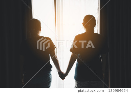 Hope and trust with crisis concept. Closeup, love and holding hands for support, comfort and care with grief, loss and empathy. people and family with compassion, sympathy and healing with bonding. Hope and trust with crisis concept. Closeup, love and holding hands for support, comfort and care with grief, loss and empathy. people and family with compassion, sympathy and healing with bonding. 129904654