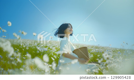 A woman standing in a flower garden 129905428