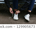 Close-up of the process of tying shoelaces. 129905673