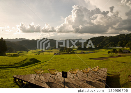 Rice terrace terraces illuminated by the setting sun, golden ears of rice, connecting rice terrace heritage, Hiwa Mikawachi rice terraces Rice terrace terraces illuminated by the setting sun, golden ears of rice, connecting rice terrace heritage, Hiwa Mikawachi rice terraces 129906796