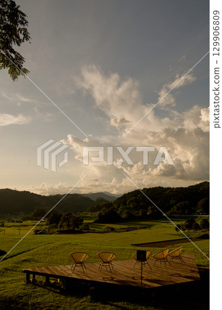 Rice terrace terraces illuminated by the setting sun, golden ears of rice, connecting rice terrace heritage, Hiwa Mikawachi rice terraces 129906809