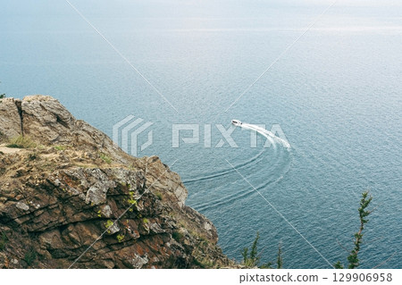 Boat leaving wake on water. Sea walks, summer vacation. 129906958