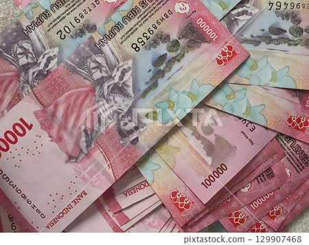 A Rich Tapestry of Indonesian Rupiah 100000 Banknotes with Cultural Motifs. A Rich Tapestry of Indonesian Rupiah 100000 Banknotes with Cultural Motifs. 129907468