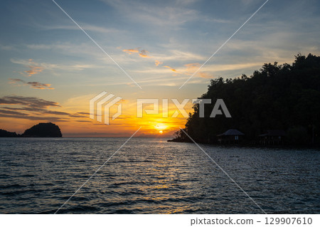 Sunset over Bolilanga Island, Togian archipelago, Sulawesi, Indonesia Sunset over Bolilanga Island, Togian archipelago, Sulawesi, Indonesia 129907610