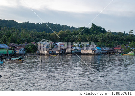 Fishermen village at sunset on Waleakodi Island, Togian archipelago, Indonesia Fishermen village at sunset on Waleakodi Island, Togian archipelago, Indonesia 129907611