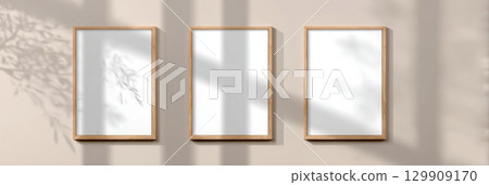 Minimalist Wall Display With Empty Frames Casting Shadows in Natural Light at a Serene Interior Space 129909170