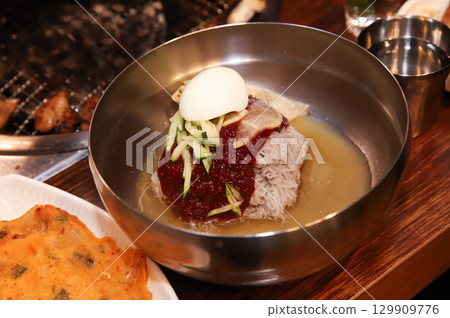 Korean noodle food. Bibim naengmyeon (cold buckwheat noodles) with Korean bbq meat 129909776