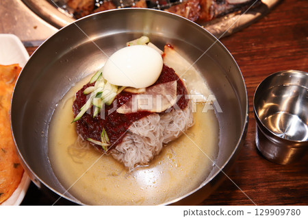 Korean noodle food. Bibim naengmyeon (cold buckwheat noodles) with Korean bbq meat 129909780