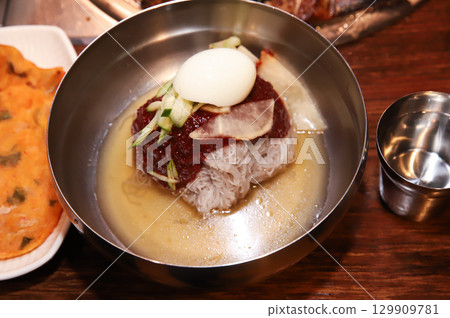 Korean noodle food. Bibim naengmyeon (cold buckwheat noodles) with Korean bbq meat 129909781