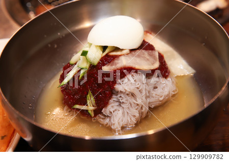 Korean noodle food. Bibim naengmyeon (cold buckwheat noodles) with Korean bbq meat 129909782