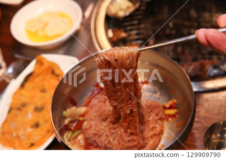 Korean noodle food. Bibim naengmyeon (cold buckwheat noodles) with Korean bbq meat Korean noodle food. Bibim naengmyeon (cold buckwheat noodles) with Korean bbq meat 129909790