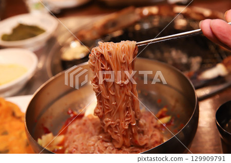 Korean noodle food. Bibim naengmyeon (cold buckwheat noodles) with Korean bbq meat 129909791