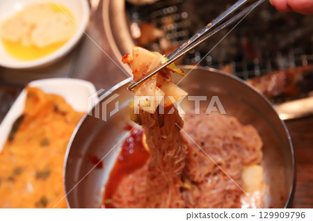 Korean noodle food. Bibim naengmyeon (cold buckwheat noodles) with Korean bbq meat Korean noodle food. Bibim naengmyeon (cold buckwheat noodles) with Korean bbq meat 129909796