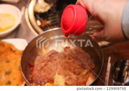 Korean noodle food. Bibim naengmyeon (cold buckwheat noodles) with Korean bbq meat Korean noodle food. Bibim naengmyeon (cold buckwheat noodles) with Korean bbq meat 129909798