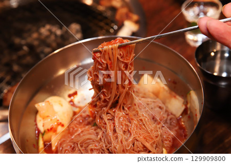 Korean noodle food. Bibim naengmyeon (cold buckwheat noodles) with Korean bbq meat 129909800