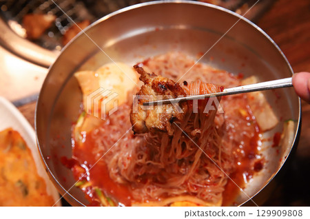 Korean noodle food. Bibim naengmyeon (cold buckwheat noodles) with Korean bbq meat 129909808