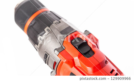 Switch in a modern screwdriver on a drill, close-up. White background, isolate, industry Switch in a modern screwdriver on a drill, close-up. White background, isolate, industry 129909966