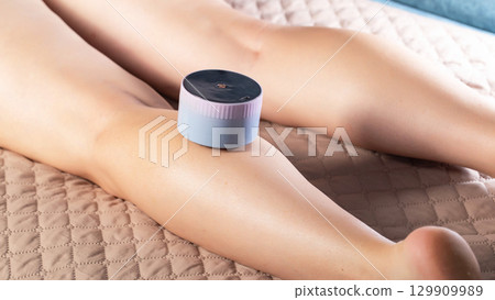 Girl gives herself a massage with a portable vacuum massager on her body. Anti-cellulite and relaxing massage, close-up Girl gives herself a massage with a portable vacuum massager on her body. Anti-cellulite and relaxing massage, close-up 129909989