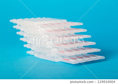Tubes with a new generation probiotic on a blue background for the treatment of intestinal diseases. Restoration of intestinal microflora during dysbacteriosis. 129910004