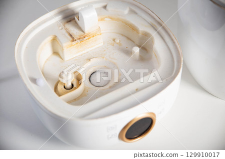 Dirty humidifier from hard water and mold. Hard water and scale, rust in white humidifier, close-up 129910017