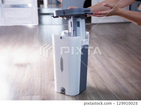 Assembling a bucket with a modern mop with a wringer for easy cleaning. Copy space for text, rinsing the mop 129910028