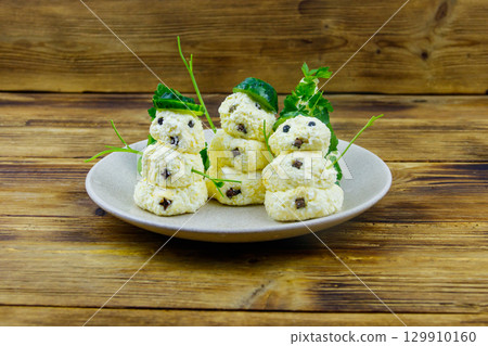 Christmas salad in the shape of snowmen and Christmas tree on a plate on wooden table Christmas salad in the shape of snowmen and Christmas tree on a plate on wooden table 129910160