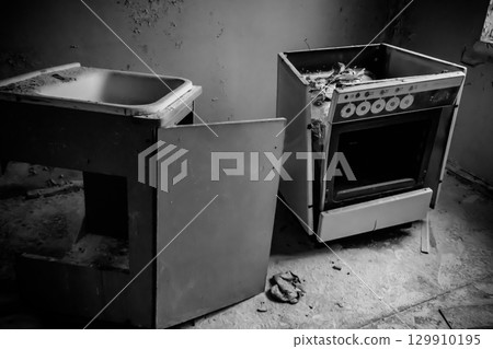 Kitchen of abandoned apartment in the ghost town Pripyat in Chernobyl Exclusion Zone, Ukraine. Black and white tone Kitchen of abandoned apartment in the ghost town Pripyat in Chernobyl Exclusion Zone, Ukraine. Black and white tone 129910195