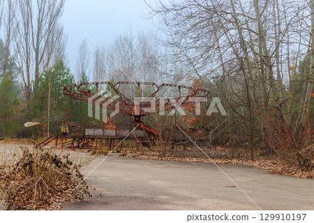 Old rusty carousel in amusement park of ghost town Pripyat in Chernobyl Exclusion Zone, Ukraine Old rusty carousel in amusement park of ghost town Pripyat in Chernobyl Exclusion Zone, Ukraine 129910197