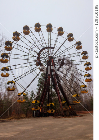 Abandoned Ferris Wheel in the amusement park of ghost town Pripyat in Chernobyl Exclusion Zone, Ukraine 129910198