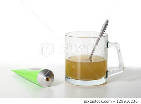 Tube with medicinal paste on herbs used in urology. Treatment of infectious inflammatory diseases of the urinary tract, close-up Tube with medicinal paste on herbs used in urology. Treatment of infectious inflammatory diseases of the urinary tract, close-up 129910236