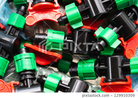 modern parts for collecting drip irrigation for plants in the country, close-up 129910309