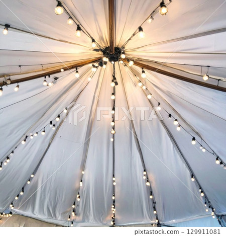 Illuminated White Tent Ceiling with String Lights and Wooden Beams for Celebration 129911081
