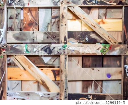 Wooden Pallet Background with Multicolored Stains and Abstract Wood Grain Texture 129911645
