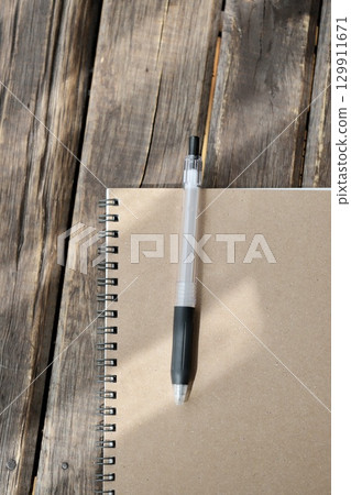 Ballpoint pen in a ring notebook 129911671