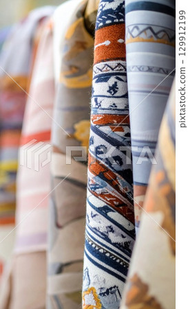 Assorted Colorful Neckties in Display with Intricate Patterns and Textile Designs 129912199