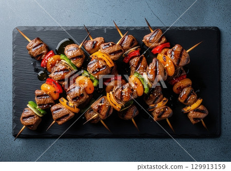 Delicious traditional south african sosaties with apricot and bell peppers on a slate platter Delicious traditional south african sosaties with apricot and bell peppers on a slate platter 129913159