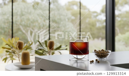 Australian wattleseed cold brew coffee with a sphere ice cube in a modern kitchen setting 129913314