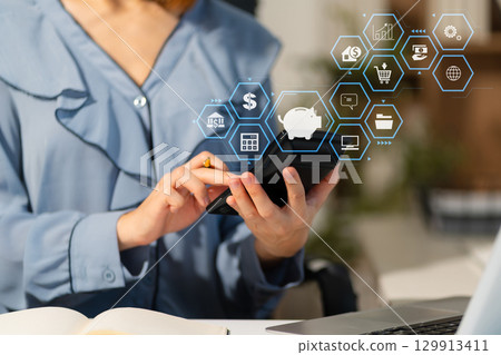 Female businessman working with holding a pen and using a calculator to calculate the numbers of static at home office. Female businessman working with holding a pen and using a calculator to calculate the numbers of static at home office. 129913411