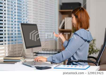 Businesswomen working with smart phone and laptop and digital tablet computer in office. Businesswomen working with smart phone and laptop and digital tablet computer in office. 129913423