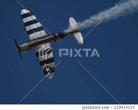 World War II aircraft flying in the blue sky 129914225