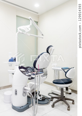 Vertical view of a dentist room with blue seat 129914393