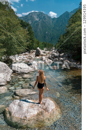 Beautiful Woman Standing in Swimsuits in Canyon River 129914395